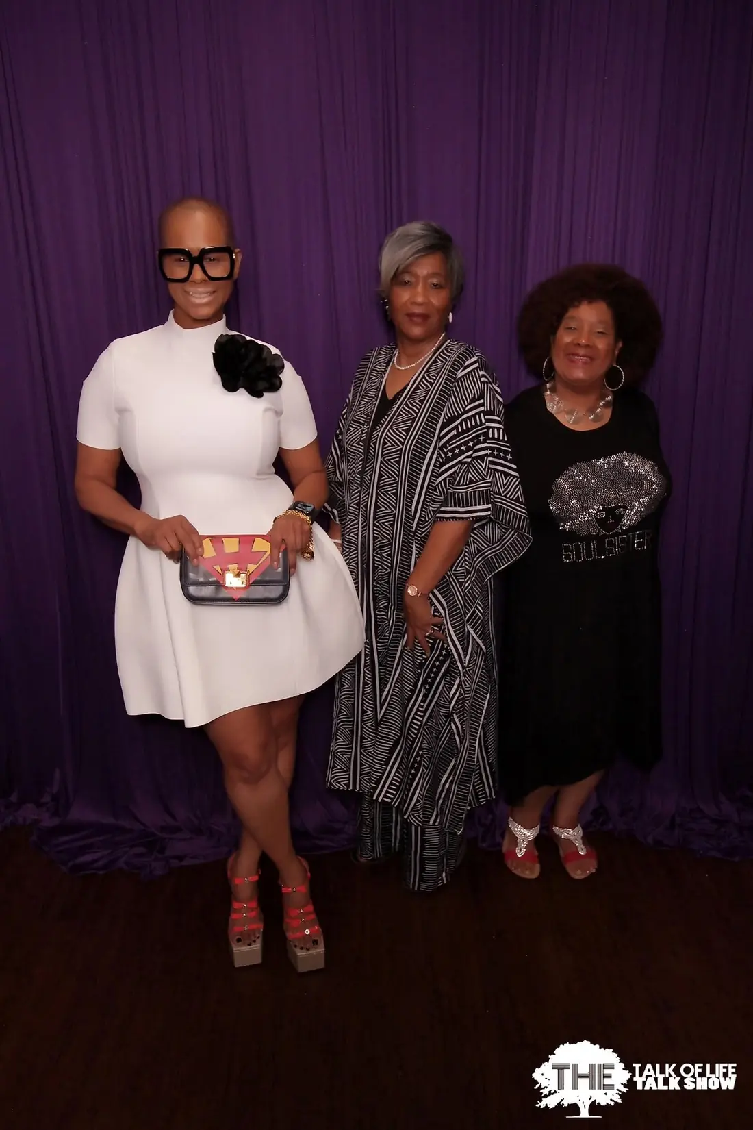 Three guests posing on The Talk of Life set